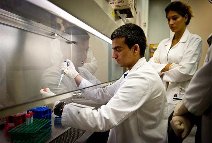 Lab technician measuring carefully